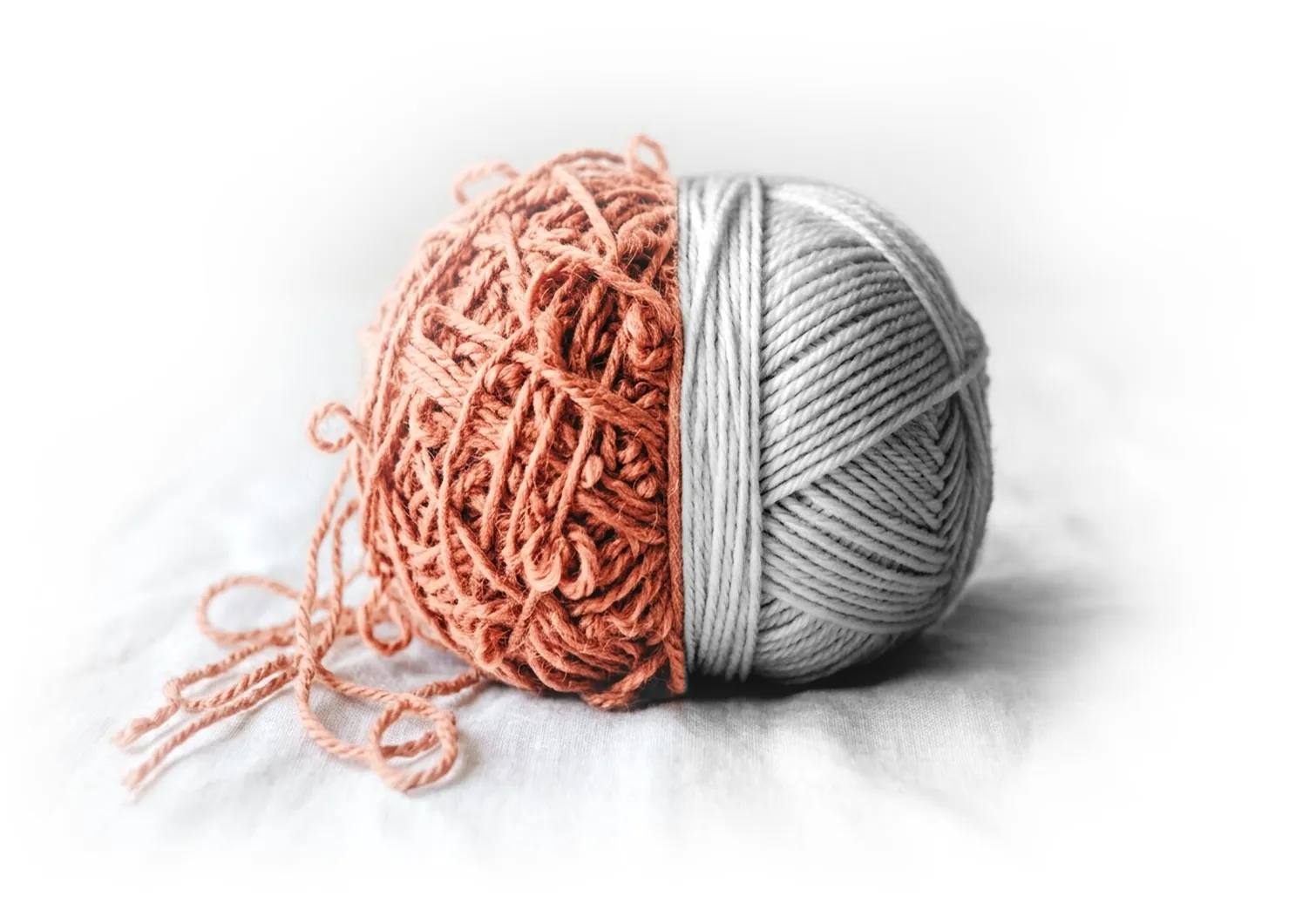 A ball of wool, half tangled and half neatly wound
